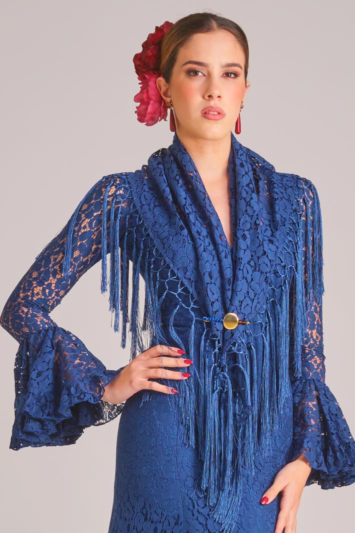 Traje de flamenca azul marino de encaje con mantoncillo a juego, flecos y mangas de volantes